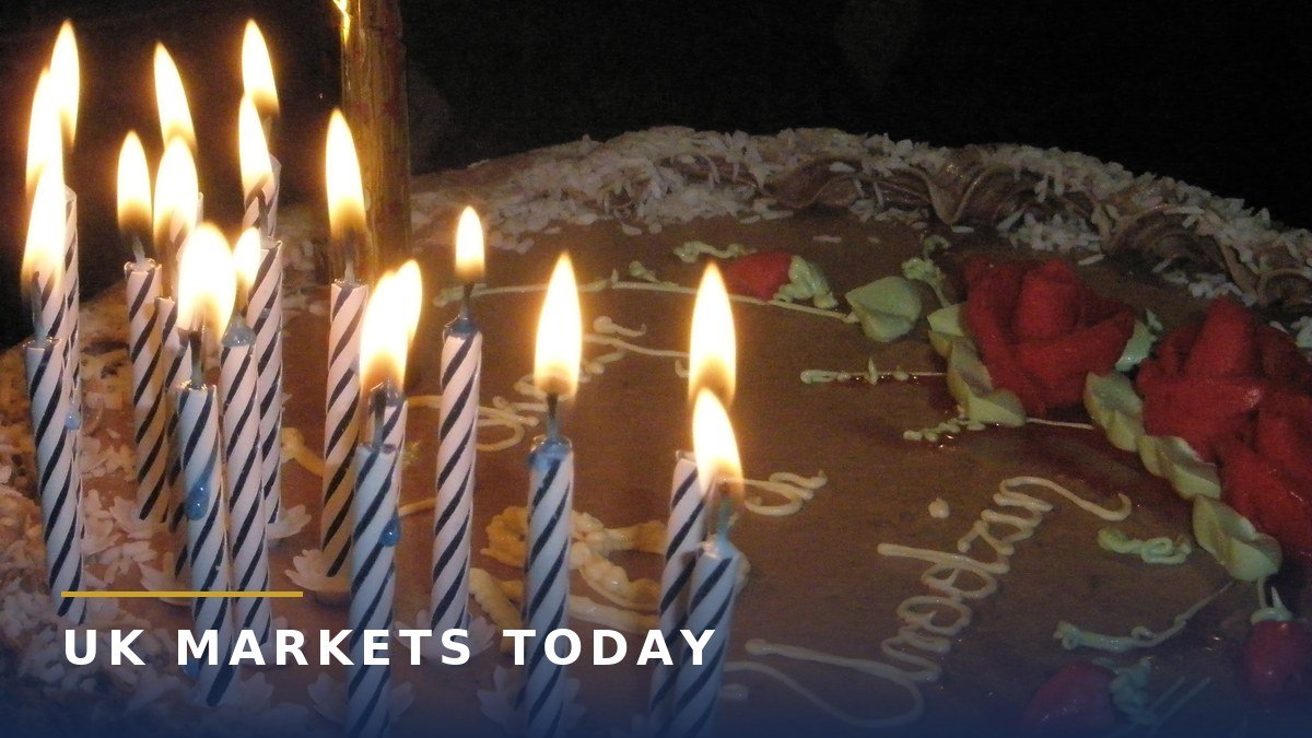 An 18th birthday cake with 18 lit candles, for young people checking a matured Child Trust Fund