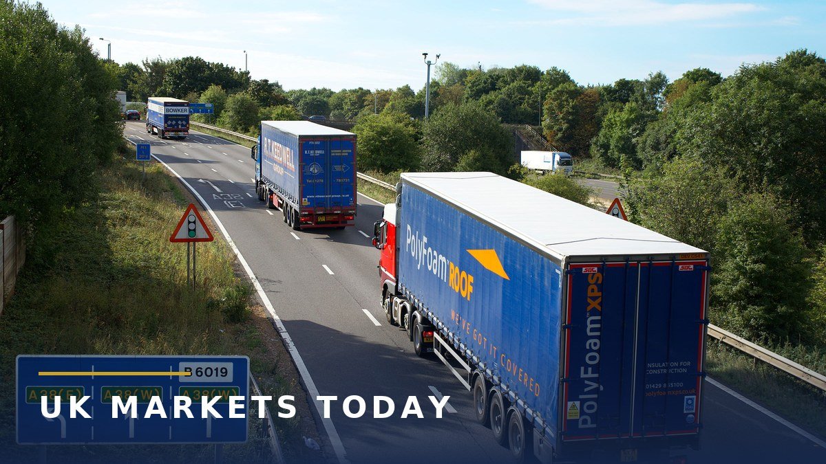 Articulated lorries driving on the A38 dual carriageway in England, illustrating the NHS lorry drivers strike by GXO drivers who deliver medical supplies to hospitals