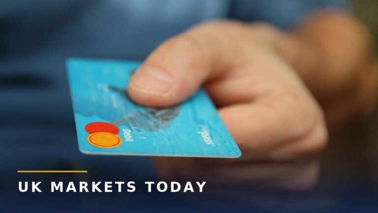 Credit cards for bad credit photo: hand holding a blue bank card, branded UK Markets Today