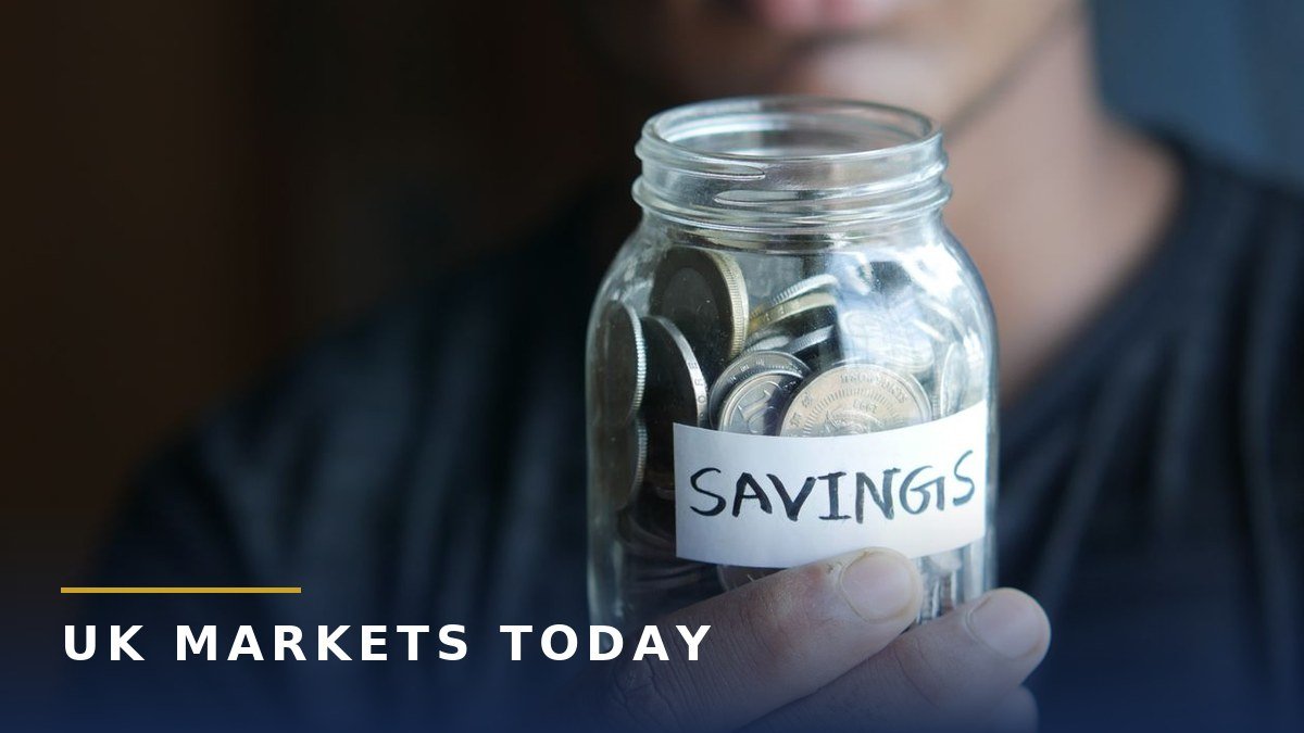 Best savings accounts photo: hand holding a jar of coins labelled savings, branded UK Markets Today