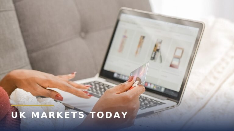 Woman shopping online on a laptop, holding a bank card. Photo by Kindel Media on Pexels.